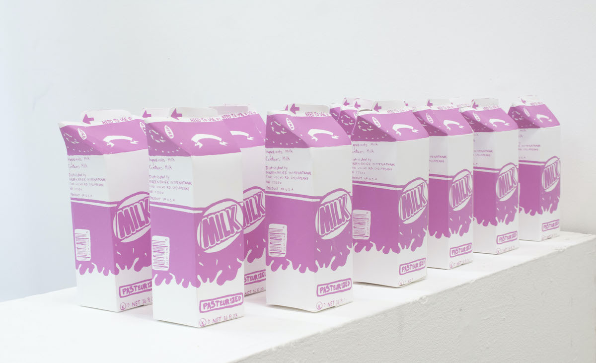 Pink and white half-gallon cartons of milk