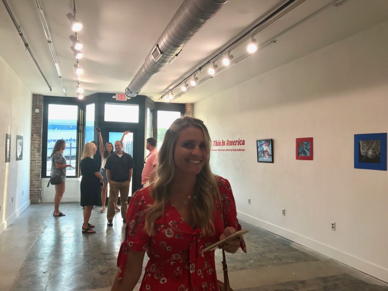 A woman in a red dress in the gallery