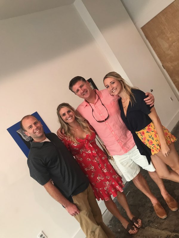 Two men and two women pose for a photo in the gallery
