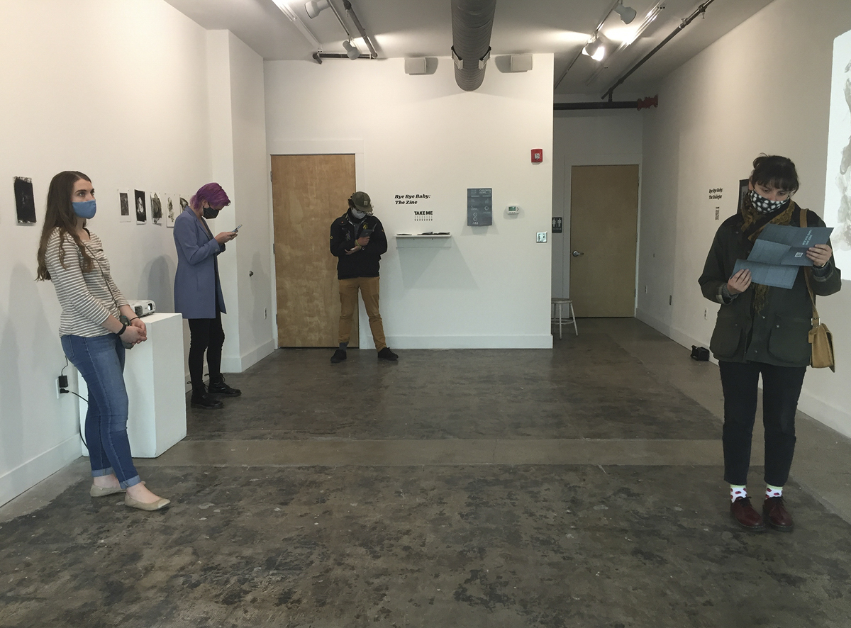A photo patrons looking at the Bye Bye Baby installation at Gallery 1010