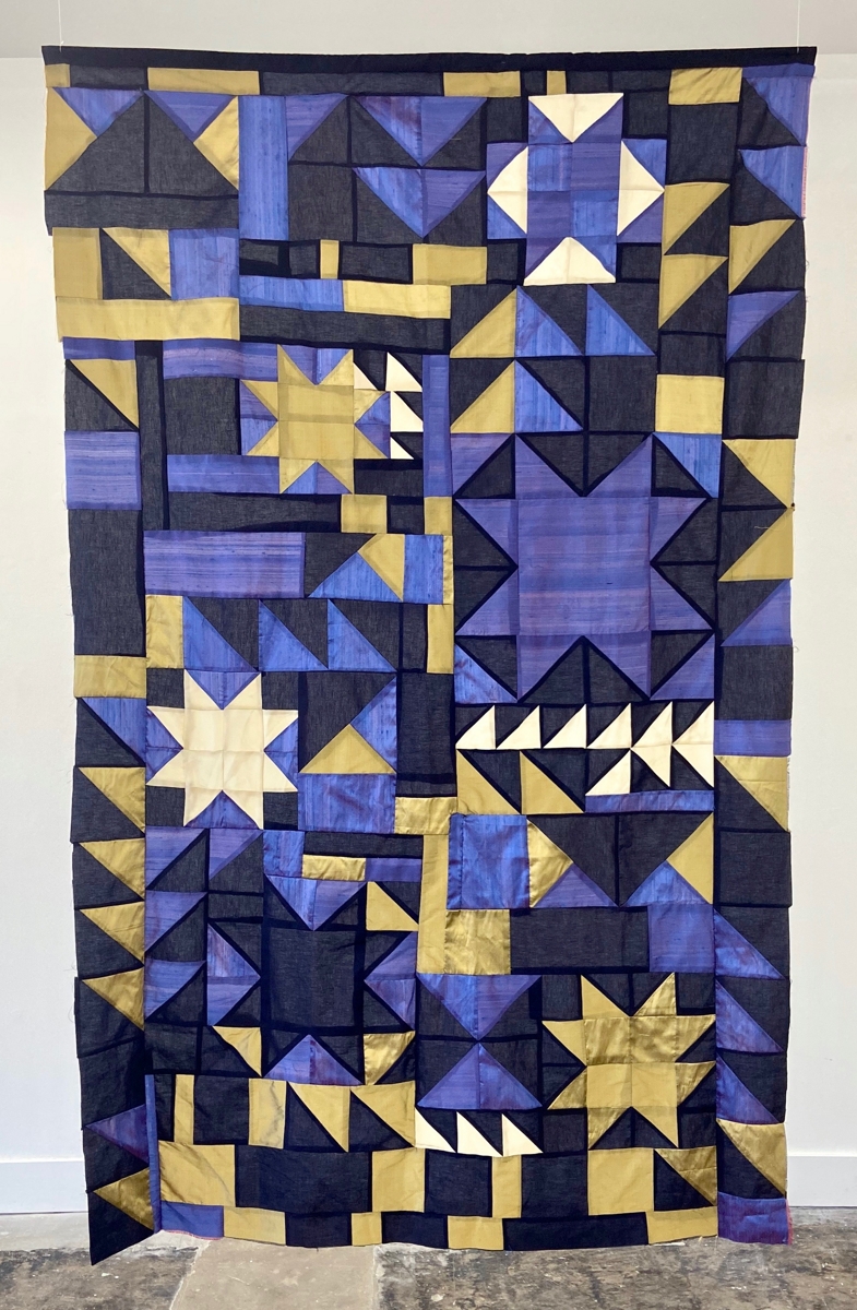 A purple, yellow, and black quilt