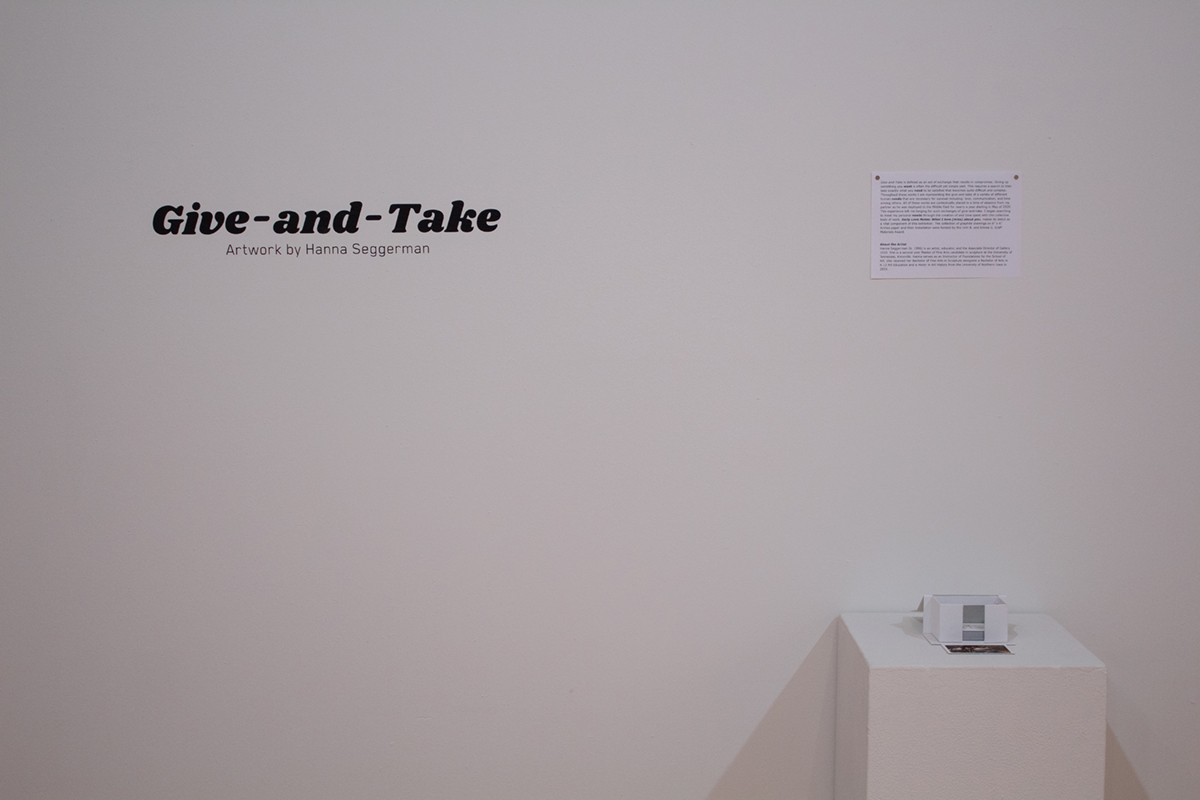Text on the wall reading Give-and-Take, Artwork by Hanna Seggerman
